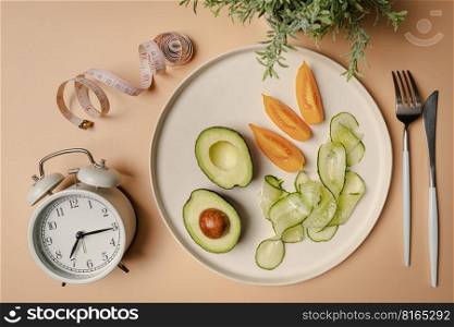 Creative flat lay composition with plate, alarm clock, knife, fork and measuring tape on pink background. Intermittent fasting, ketogenic, diet concept. top view, copy space.. Creative flat lay with diet concept