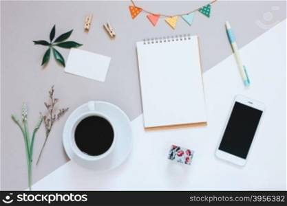 Creative flat lay design of cute workspace desk with notebook, coffee, smartphone and decorated cute craft with copy space background, minimal style&#xD;