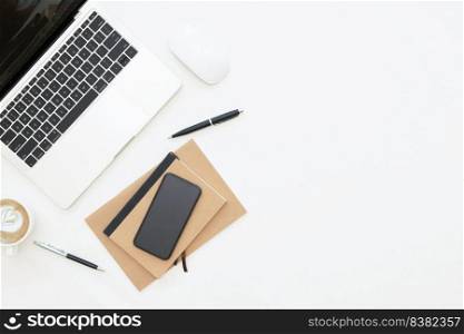 Creative flat lay design of workspace desk with laptop, laptop, blank notebook, smartphone and stationery with copy space background