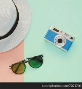 Creative Flat lay fashion style with camera, sunglasses and panama hat on pastel color background