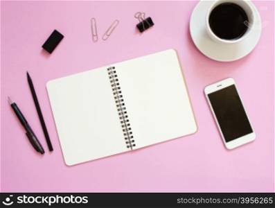 Creative flat lay mockup design of workspace desk with blank notebook, smartphone, coffee, stationery with copy space background&#xA;&#xA;