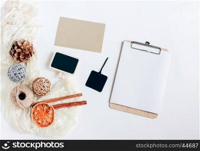 Creative flat lay of blank clipboard, card, blackboard and tag with autumn ornaments on white background, top view