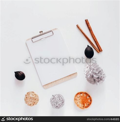 Creative flat lay of blank clipboard with autumn ornaments on white background, top view