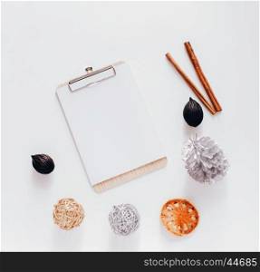 Creative flat lay of blank clipboard with autumn ornaments on white background, top view