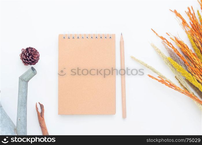 Creative flat lay of blank notebook and pencil on white background, Autumn lifestyle