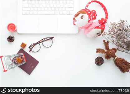 Creative flat lay of Christmas and holiday concept with notebook and Christmas decorations on white background