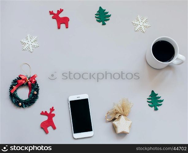 Creative flat lay of christmas craft and blank copy space with smartphone and cup of coffee, top view