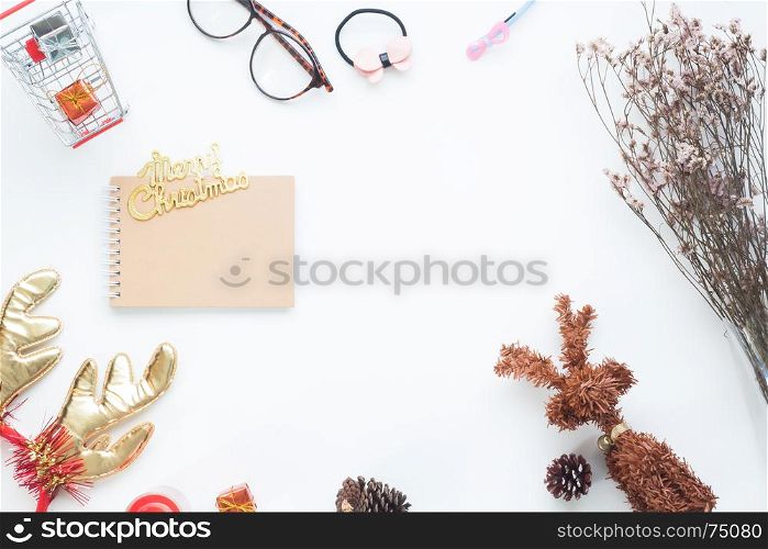 Creative flat lay of Christmas decorations and notebook on white background with copy space