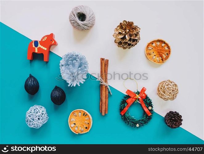 Creative flat lay of christmas ornaments and craft objects in minimal style on colorful background, top view