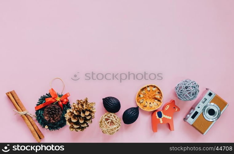 Creative flat lay of christmas ornaments in minimal style with copy space on pink background, top view