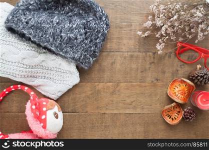 Creative flat lay of Christmas ornaments, winter accessories on wood background, Top view