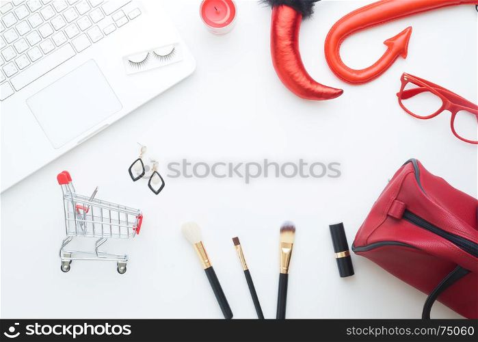 Creative flat lay of Halloween and fashion concept with laptop and shopping cart on white background, Online shopping