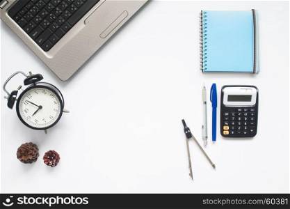 Creative flat lay of school supplies and laptop on white background with copy space