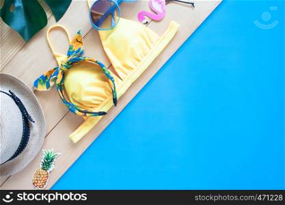 Creative flat lay of summer concept with trendy swimwear, straw hat and beach items. Summer vacation concept