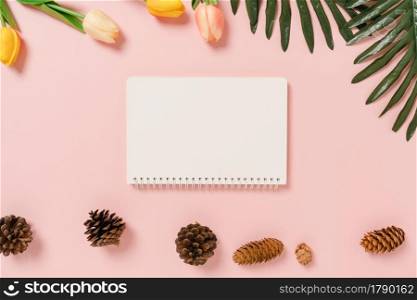 Creative flat lay of travel vacation spring or summer tropical fashion. Top view beach accessories open mockup black notebook for text on pastel background. Top view mock up copy space photography.