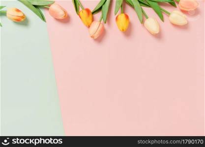 Creative flat lay of travel vacation spring or summer tropical fashion. Top view beach accessories on pastel green pink color background with blank space for text. Top view copy space photography.