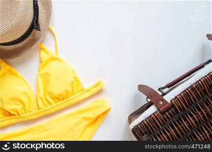 Creative flat lay of trendy bikini and summer accessories on white background. Travel vacation concept