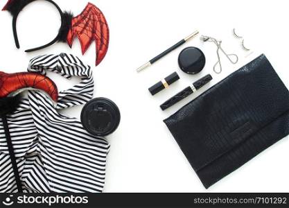 Creative flat lay of woman dress and accessories for Halloween party on white background.
