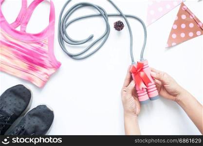 Creative flat lay of woman hands give present with sport items and equipments, Healthy lifestyle, Gift for health