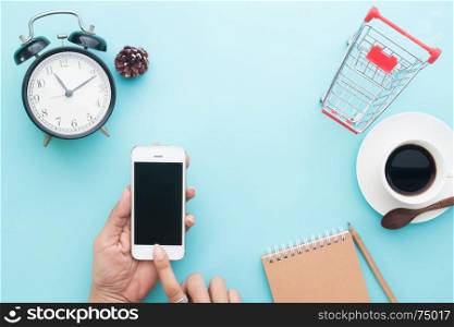 Creative flat lay of woman hands using smartphone, Online shopping concept on blue color background