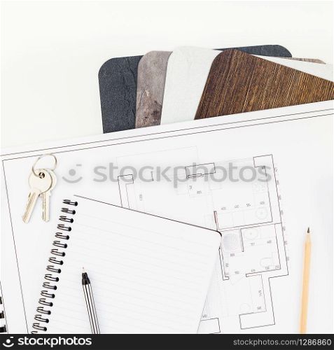 Creative flat lay overhead top view blueprint flat project plan and office supplies on decorator table workspace swatches tools and equipment background copy space concept