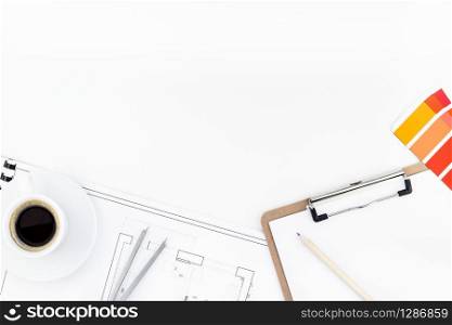 Creative flat lay overhead top view blueprint flat project plan hot coffee cup and office supplies on decorator table workspace swatches tools and equipment background copy space concept