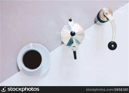 Creative flat lay photo of coffee workspace with coffee maker, coffee grinder and black coffee, minimal style&#xD;