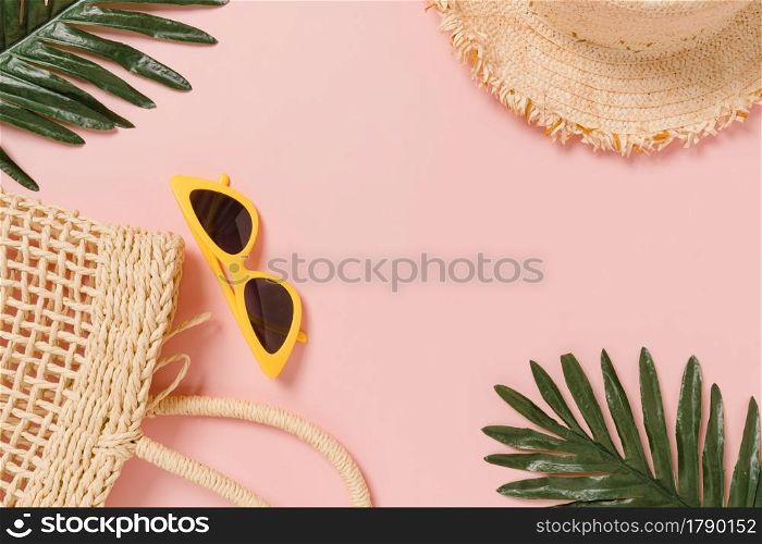 Creative flat lay photo of travel vacation spring or summer tropical fashion. Top view beach accessories on pastel pink color background with blank space for text. Top view copy space photography.
