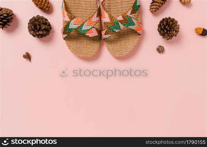 Creative flat lay photo of travel vacation spring or summer tropical fashion. Top view beach accessories on pastel pink color background with blank space for text. Top view copy space photography.
