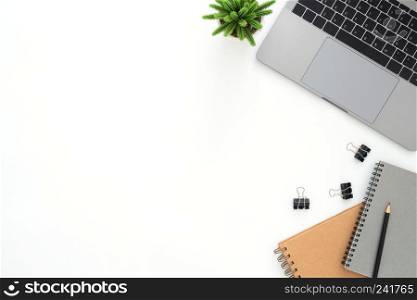 Creative flat lay photo of workspace desk. Top view office desk with laptop, pencil, notebook and plant on white color background. Top view with copy space, flat lay photography.