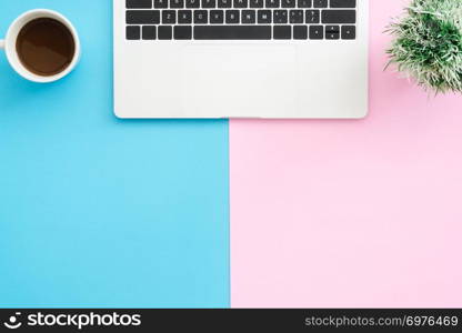 Creative flat lay photo of workspace desk. Top view office desk with laptop, plant and coffee cup on blue pink color background. Top view with copy space, flat lay photography.