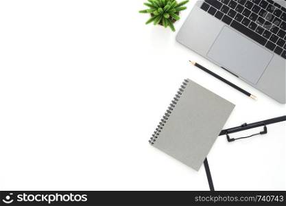 Creative flat lay photo of workspace desk. Top view office desk with laptop, pencil, notebook and plant on white color background. Top view with copy space, flat lay photography.