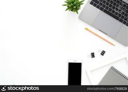 Creative flat lay photo of workspace desk. Top view office desk with laptop, phone, pencil, notebook and plant on white color background. Top view with copy space, flat lay photography.