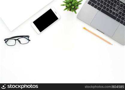 Creative flat lay photo of workspace desk. Top view office desk with laptop, phone, pencil and plant on white color background. Top view with copy space, flat lay photography.