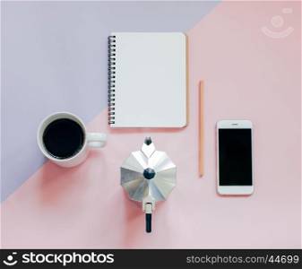 Creative flat lay photo of workspace desk with blank notebook, smartphone, pencil, coffee and mokat pot with copy space background, minimal style