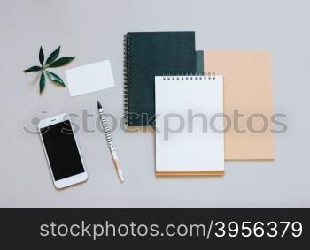 Creative flat lay photo of workspace desk with smartphone, coffee and notebook with copy space background, minimal style&#xD;