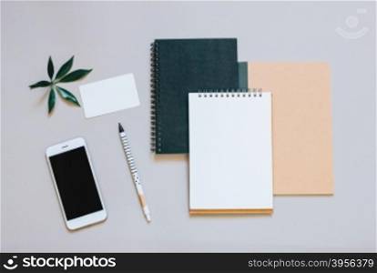 Creative flat lay photo of workspace desk with smartphone, coffee and notebook with copy space background, minimal style&#xD;