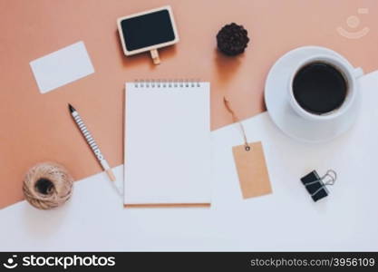 Creative flat lay photo of workspace desk with smartphone, coffee, tag and notebook with copy space background, minimal styled&#xD;