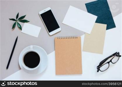 Creative flat lay photo of workspace desk with smartphone, coffee, tag, letter and notebook with copy space background, minimal style&#xD;