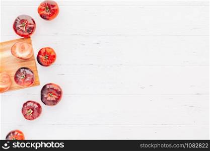 Creative flat lay top view mockup of exotic spanish made tomatoes Mar Azul on white wooden table background copy space. Minimal house cooking concept mock up for blog or recipe book