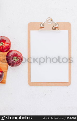 Creative flat lay top view mockup of exotic spanish made tomatoes Mar Azul on white wooden table background copy space. Minimal house cooking concept mock up for blog or recipe book