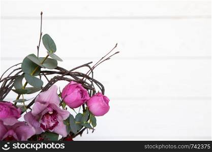 Creative flower bouquet on white wooden background. Focus on flowers, background is blurred. Mockup with copy space for greeting card, social media, flower delivery, Mother?s day, Women?s Day.