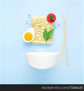 Creative food diet healthy eating concept photo of tasty ramen noodle pasta with vegetables tomato egg greens chopsticks and bowl on blue background.