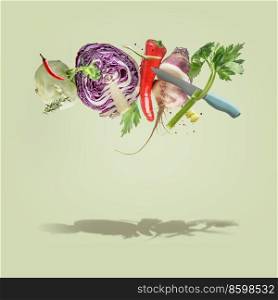 Creative food  levitation concept with flying various colorful vegetables and knife at pale green background. Healthy lifestyle
