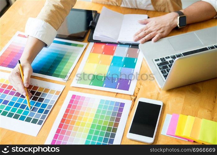 Creative Graphic designer at work. Color swatch s&les pantone palette in studio modern office, interior design, renovation and technology concept