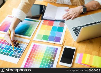 Creative Graphic designer at work. Color swatch s&les pantone palette in studio modern office, interior design, renovation and technology concept