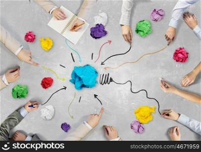 Creative group at work. Top view of business people working together while sitting at table