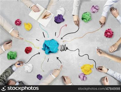 Creative group at work. Top view of business people working together while sitting at table