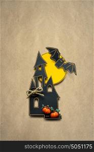 Creative halloween concept photo of a castle made of paper on brown background.