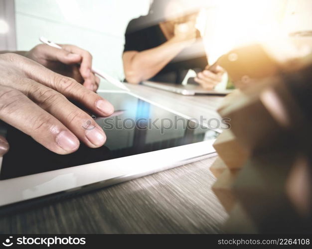 creative hand working digital tablet and wood puzzle with laptop computer and tablet computer as design concept